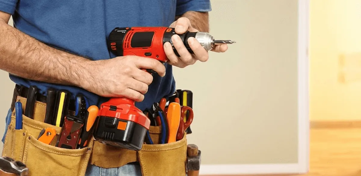 Handyman holding a power drill for home repairs and installations in Scottsdale, AZ