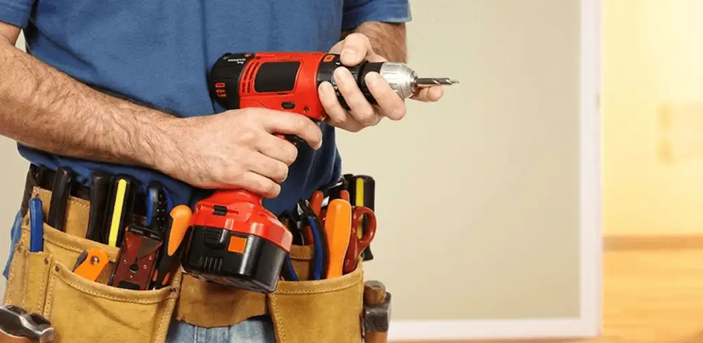 Handyman holding a power drill for home repairs and installations in Scottsdale, AZ