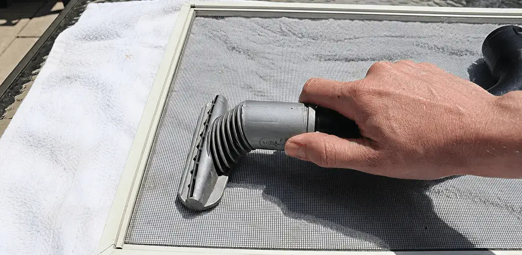 Window screen repair cleaning and fixing a damaged screen mesh in Scottsdale, AZ
